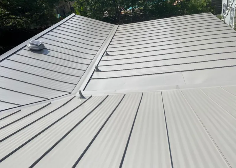 Solar attic fan installed on a metal roof for Roof Ventilation in Hampstead
